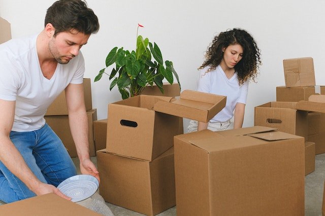 two people packing their boxes for relocation